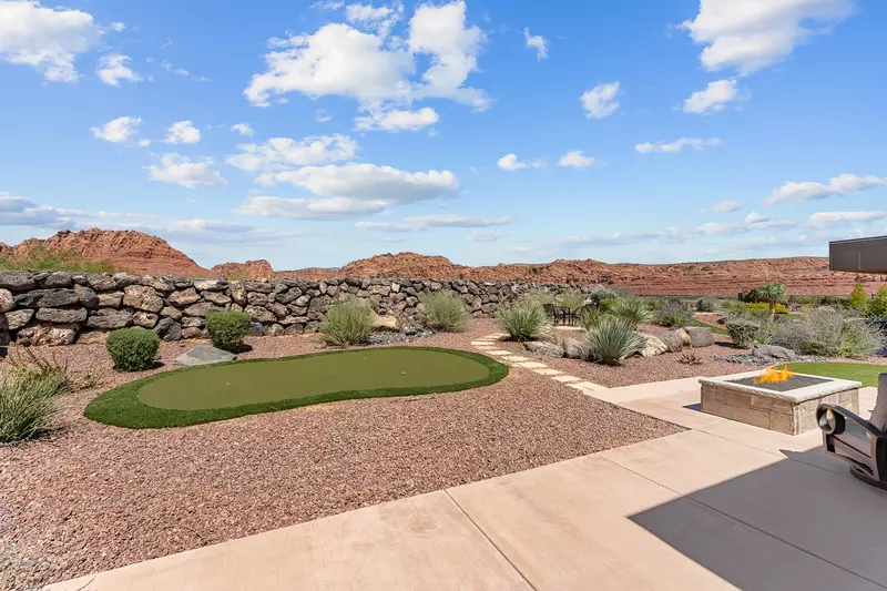 Backyard with Putting Green, Dining Tables, Grill, & Firepit